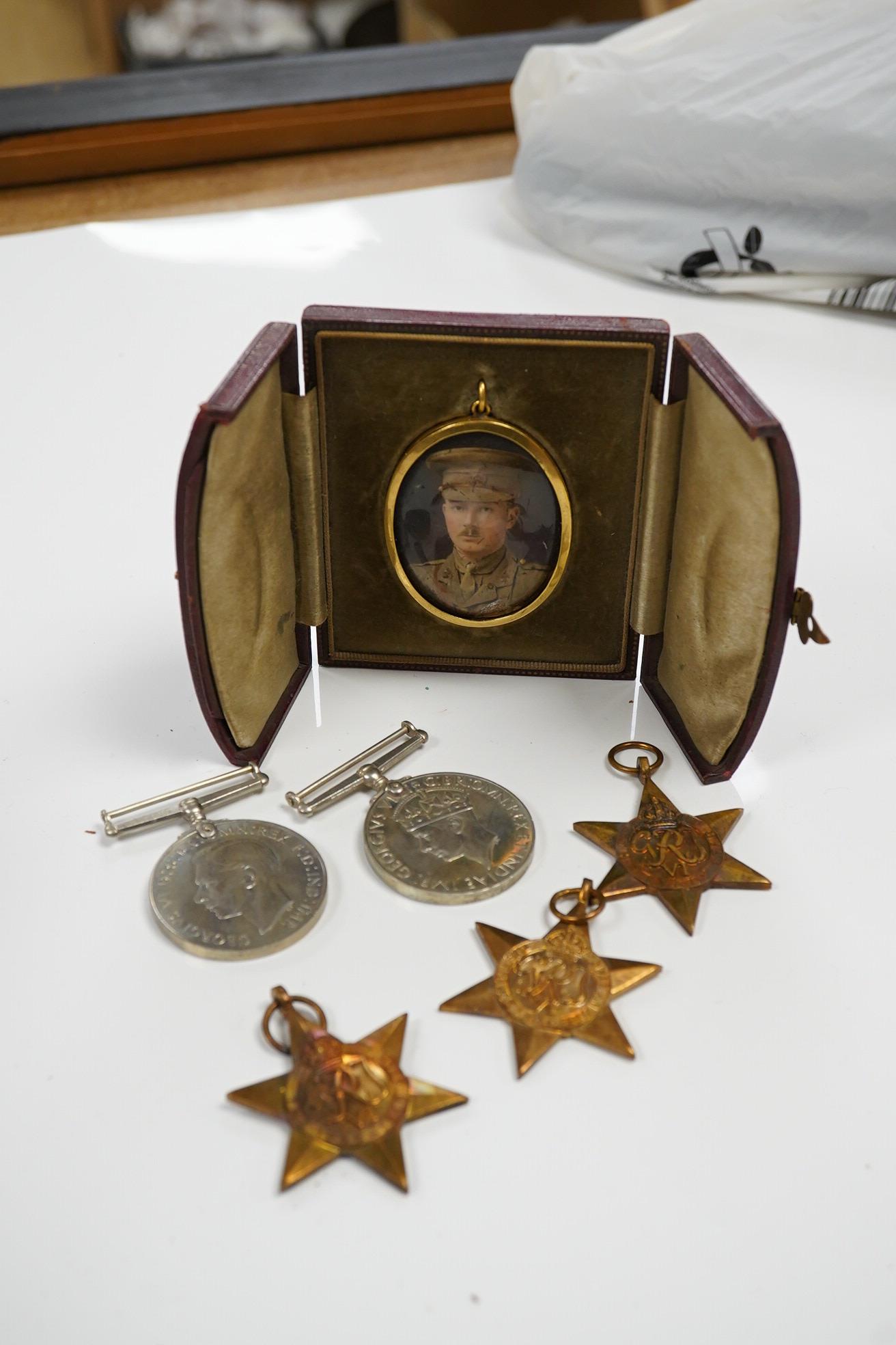 Five WWII medals including the Italy star, the France and Germany star, etc. and a cased miniature of a First World War officer in uniform, plus a leather cylindrical case. Condition - fair to good, significant chip to t